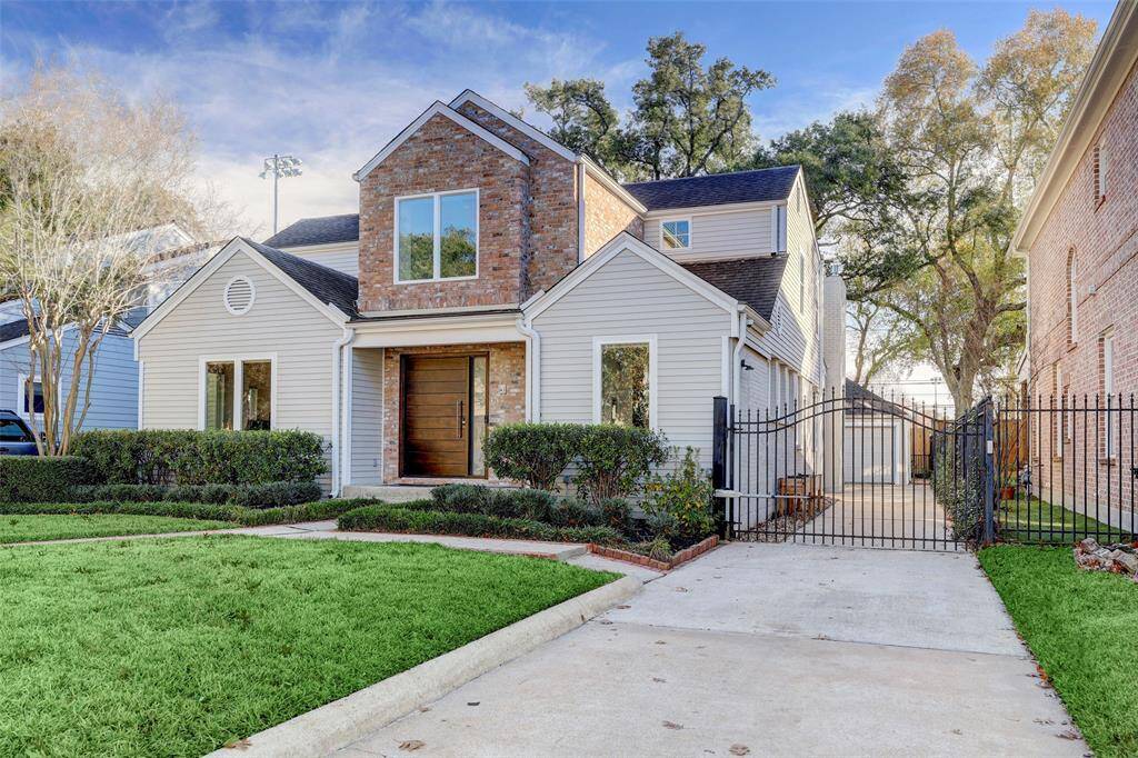 An automatic gate offers access to the driveway and garage.
