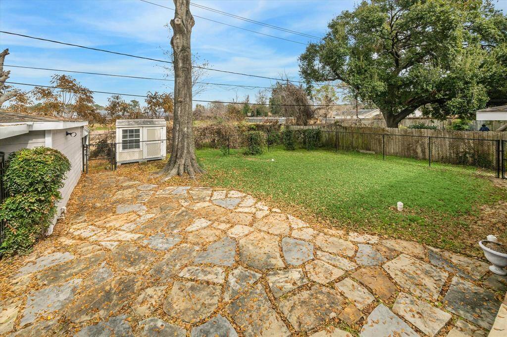 Take another peek at your new back yard with an expansive flagstone patio, towering trees, and ample space for outdoor play for kids AND/OR pets with oversized dog house and L shaped Dog Run!