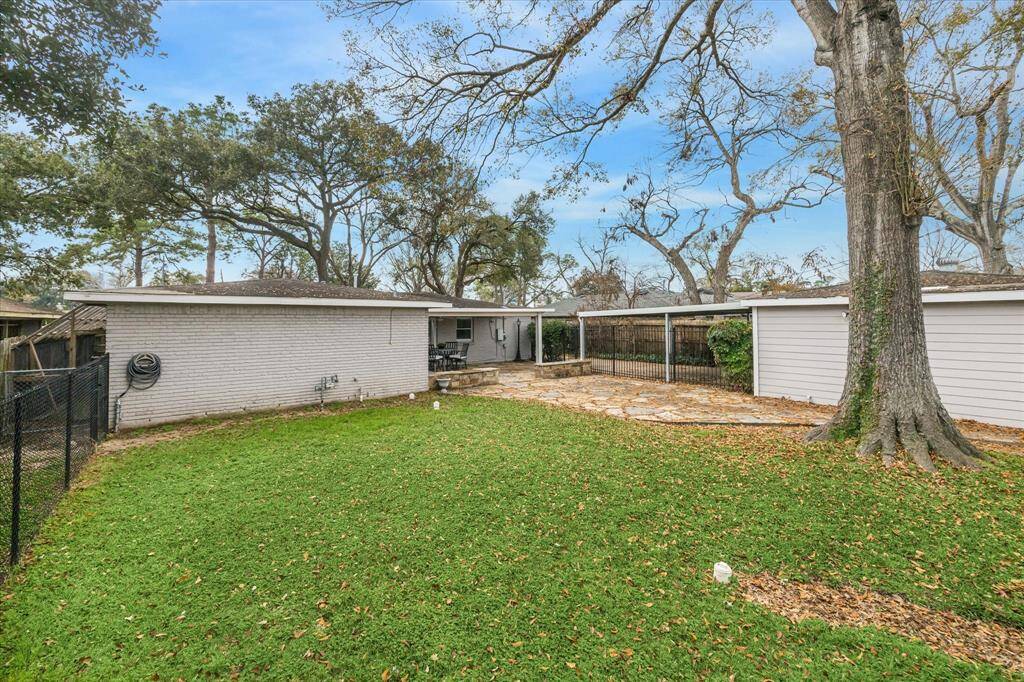 This sprawling fenced yard is ready for barefoot fun with plenty of grassy lawn for outdoor play.