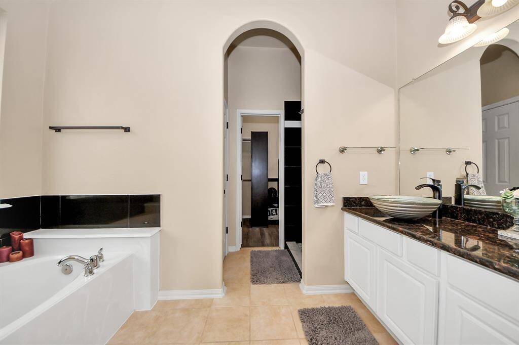 Ensuite primary bath leading to oversized closet