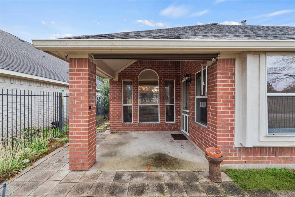 Covered rear patio overlooking lake and walking trails