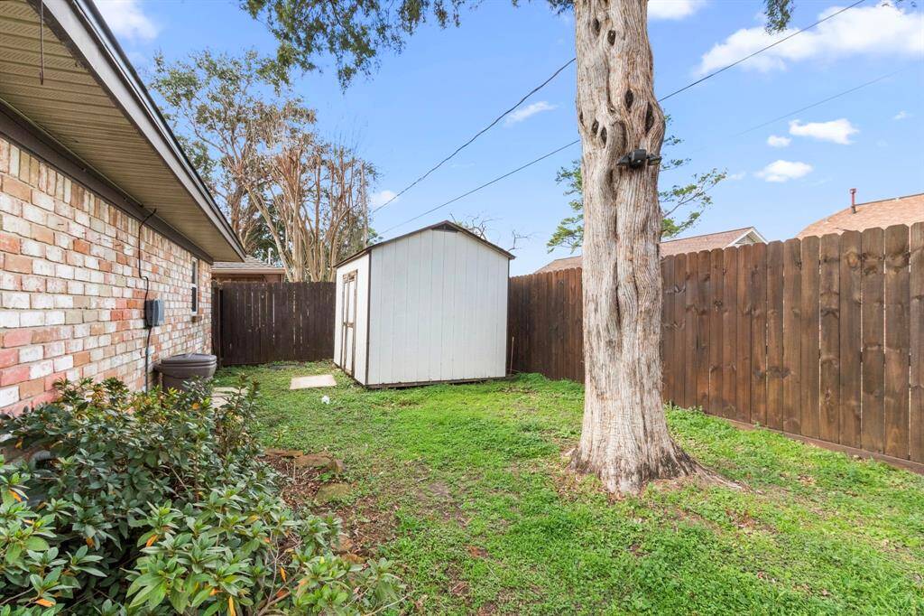 Storage building located in the back corner with gate access to side yard and garage. Gate access is on both sides of the property.