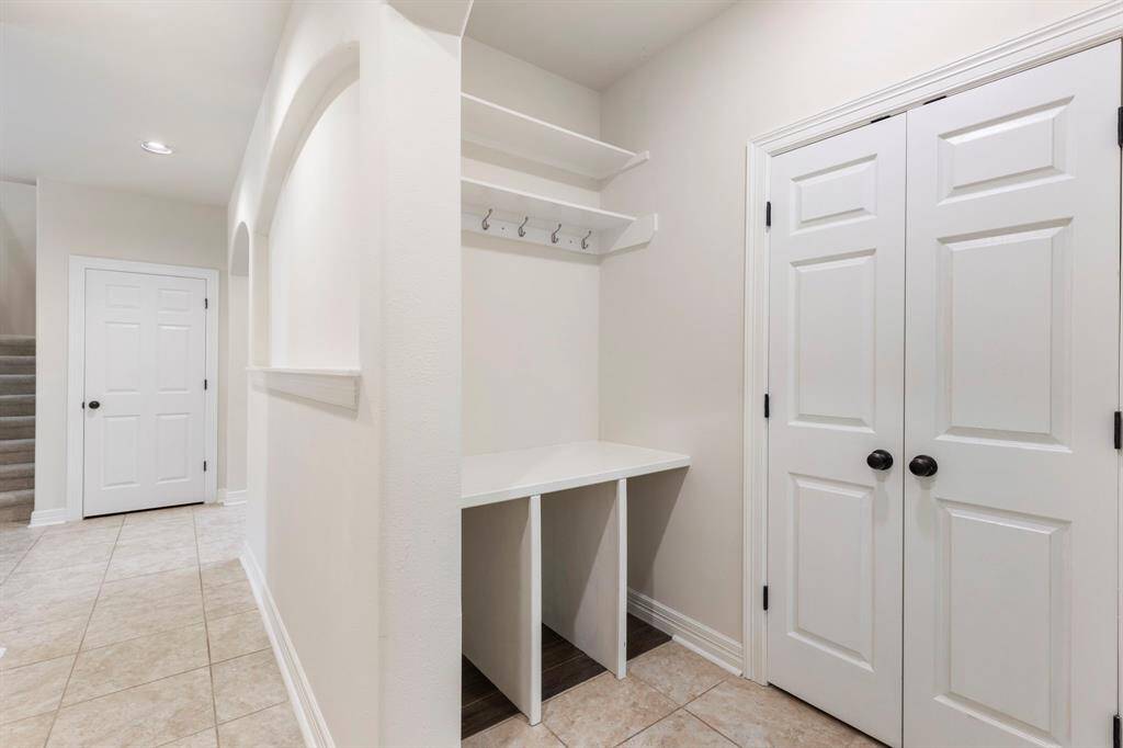 Storage galore in this awesome floorplan including this mud room just outside of the utility room and garage entry.