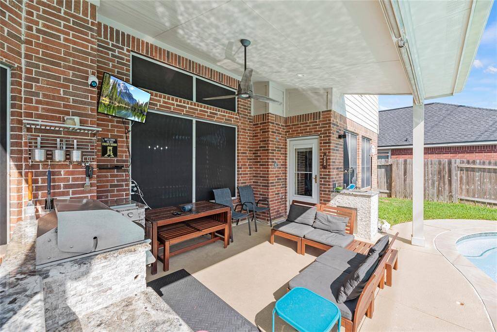 Back covered patio with outdoor kitchen
