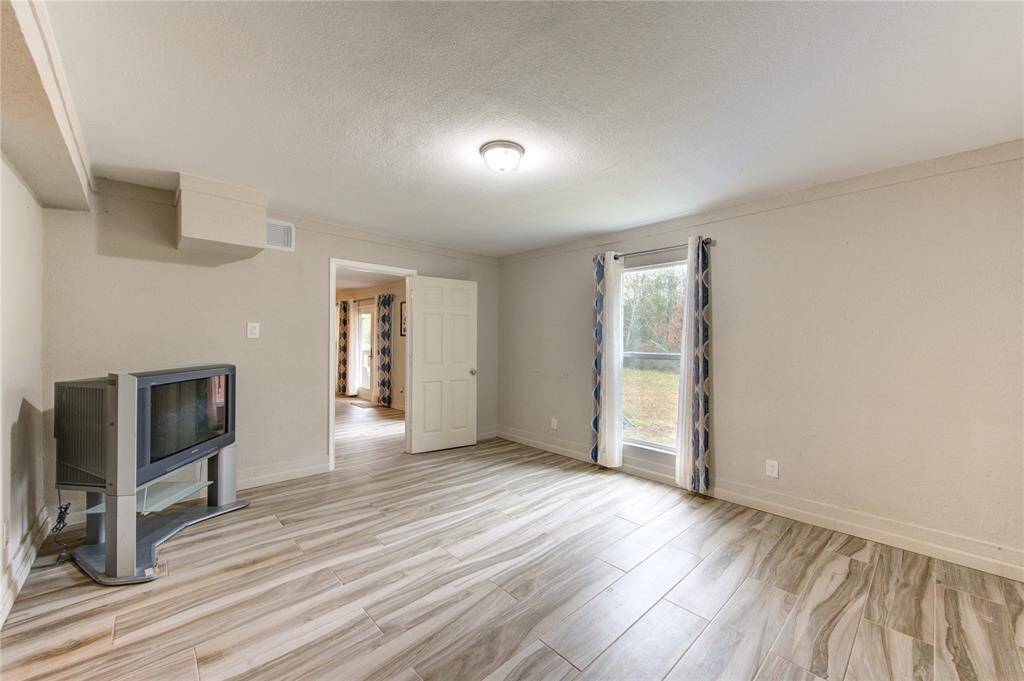 Just off the downstairs living room, you'll find a versatile space that can serve as either a home office or an additional bedroom.