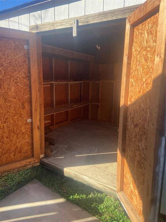 Two car attached garage with 2 work bench areas and door exit to side yard.