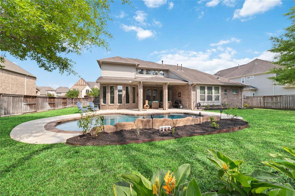 Large backyard lot with lush landscaping and salt water pool