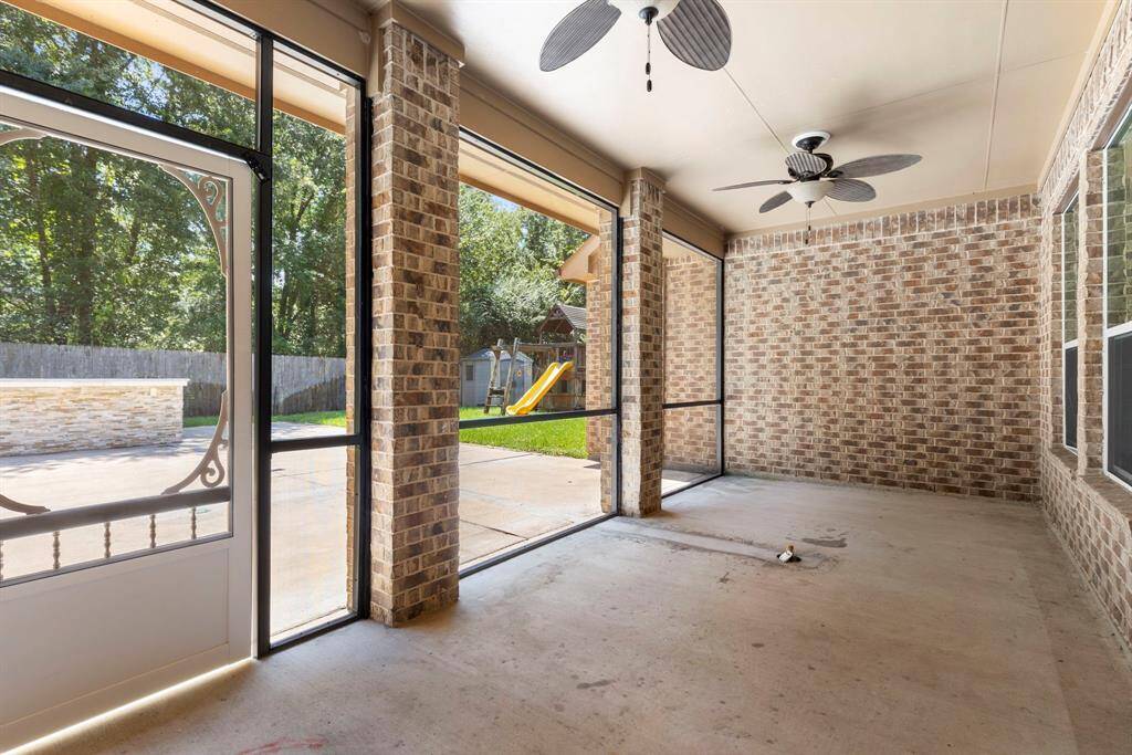Enjoy your outdoor oasis come rain or shine with this fully enclosed screened-in back patio with double ceiling fans and plumbed with a gas line, perfect for a gas fire pit!