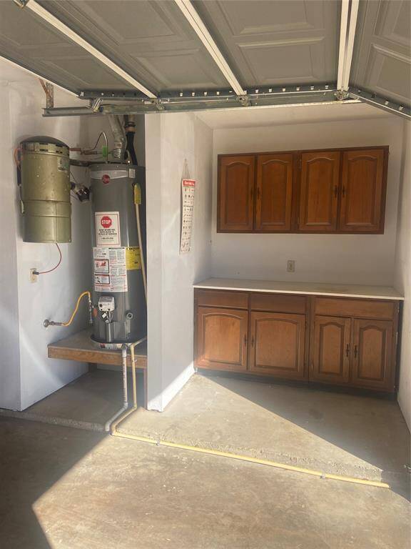 Second workbench area off garage right side next to water heater and Vacu-maid Central Vacuum Cleaning System.