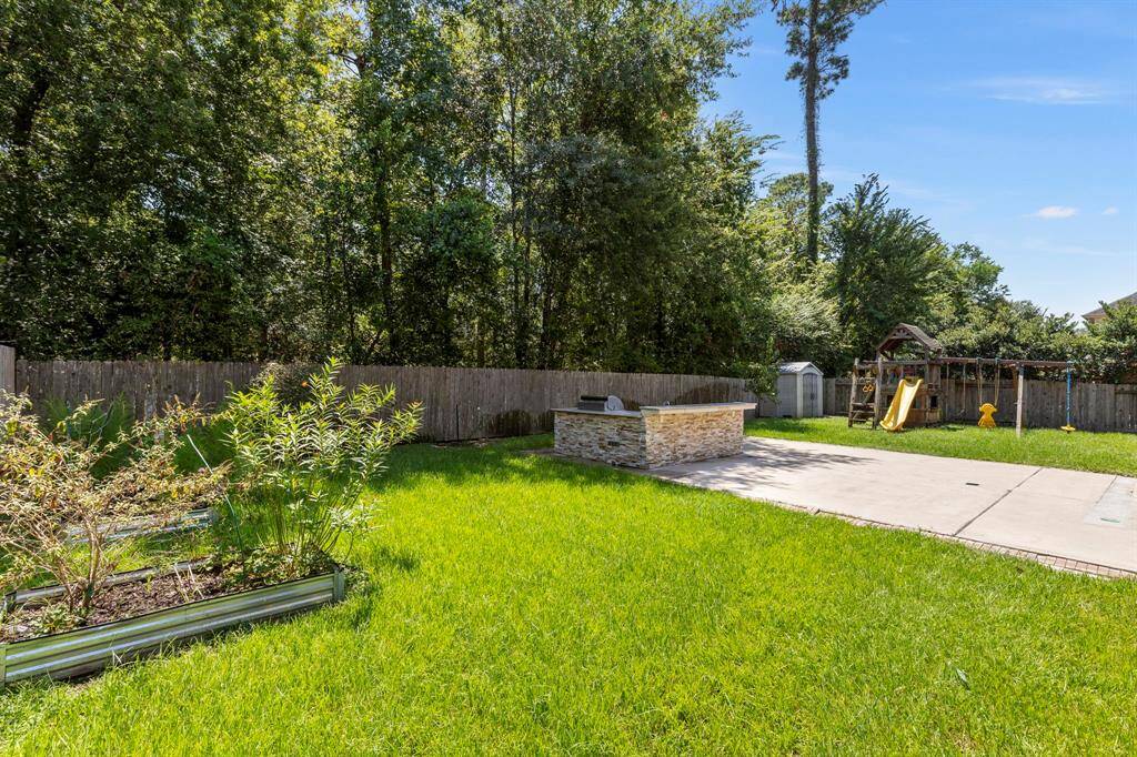 Mature trees provide ultimate privacy in this huge backyard.