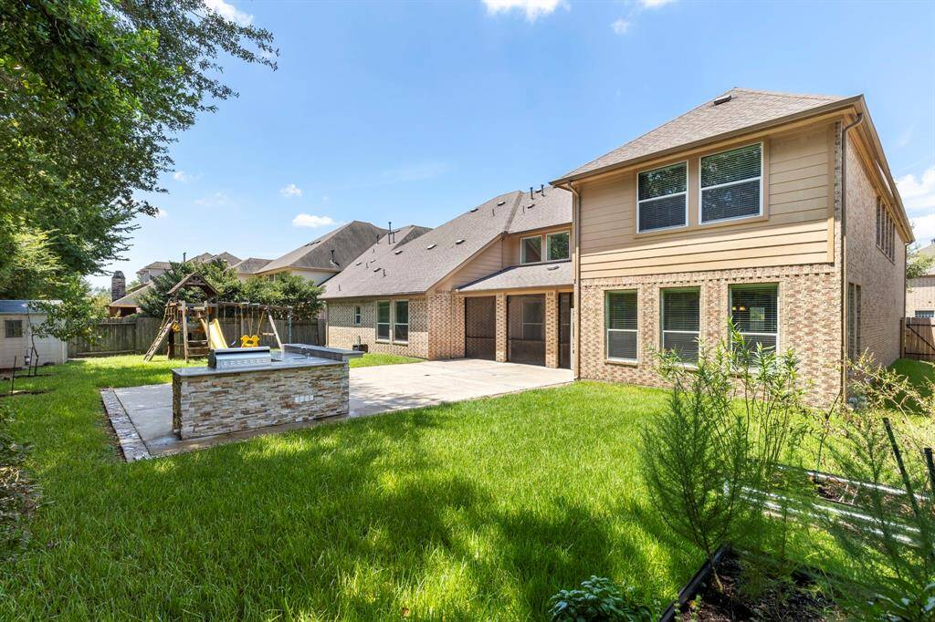 This backyard provides plenty of space for kids and pets to run around. The seller has also provides planter boxes for gardening.