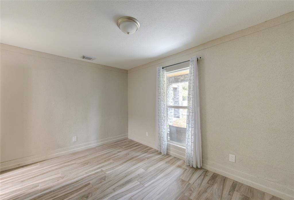 Another view of Bedroom Number 5 with durable tile flooring.