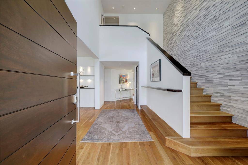 The first glimpse inside will take your breath away. With it's high ceilings, stone accents, wood flooring and modern aesthetic, you can see that no expense was spared.