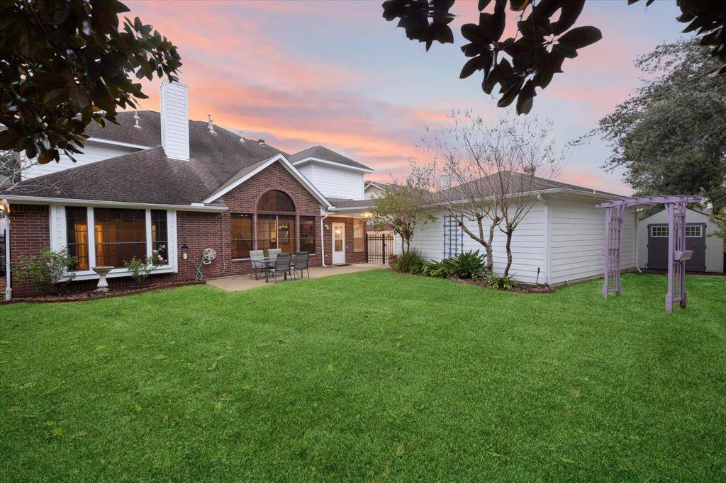 Beautifully landscaped backyard with storage shed.