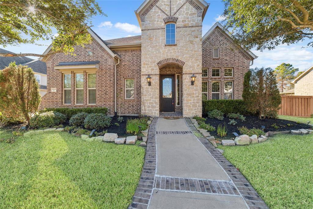 Coventry-built 2-story home with stone and brick elevation and upgraded walkway