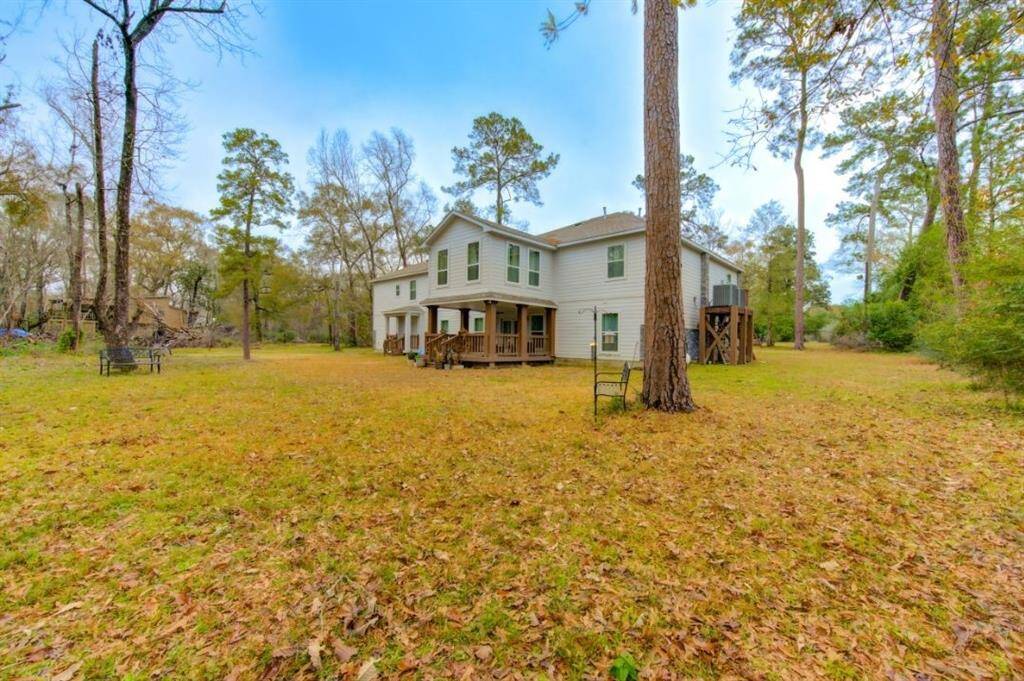 The back of the home offers an incredible view, seamlessly blending architectural elegance with the beauty of nature. The back patio, thoughtfully designed with ample seating, creates the perfect setting to relax and take in the stunning natural surroundings.