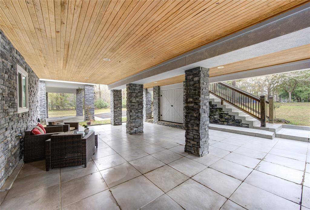 Beneath the front of the house, a unique and versatile space offers endless possibilities. To the right, stairs lead upstairs, providing easy access to the main level while maintaining a seamless flow throughout the home. This home was built for entertaining!