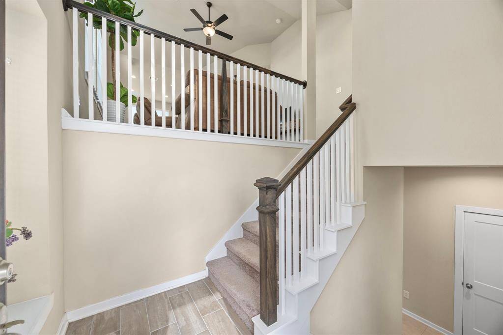Enter the home and choose to go up to the main living floor or down to the garage, secondary bedrooms, and gameroom.