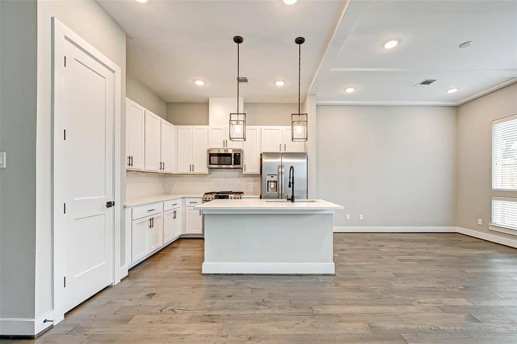 The 9x11 SF kitchen has a large pantry and custom cabinets.
