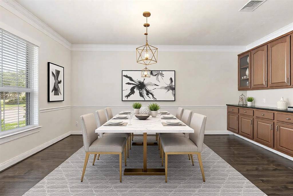The formal dining room provides plenty of space to entertain tons of guests. This room has been virtually staged.