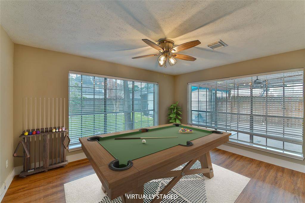 Sunroom facing back yard could be a game room, work-out room, craft room, and more