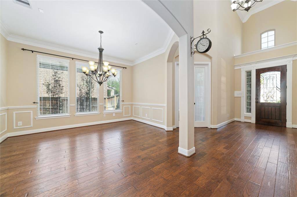 Wide formal dining room with elegant chair rails and crown molding