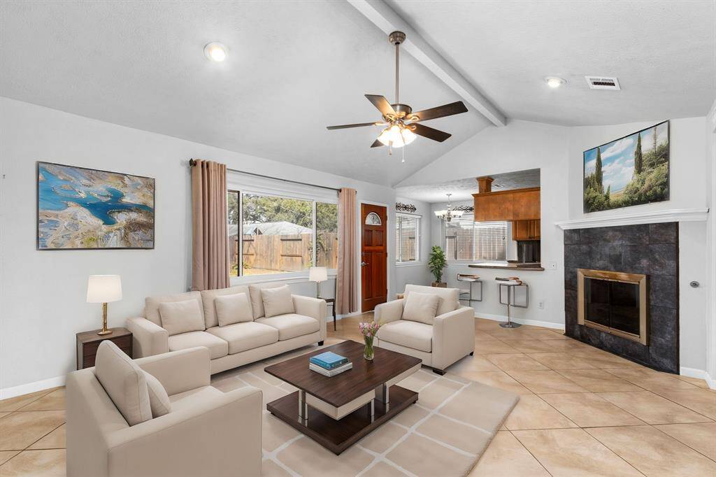 Virtually staged image to illustrate a possible layout. Don't get too excited- this furniture isn't real so you can't have it. Imagine your current or NEW furniture here! Vaulted ceiling, recessed lights, gas log fireplace.