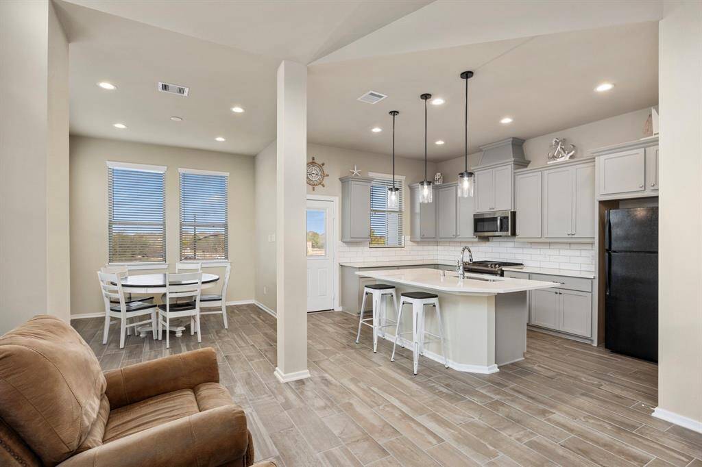 Expansive living room connects directly to the dining area and upscale kitchen.