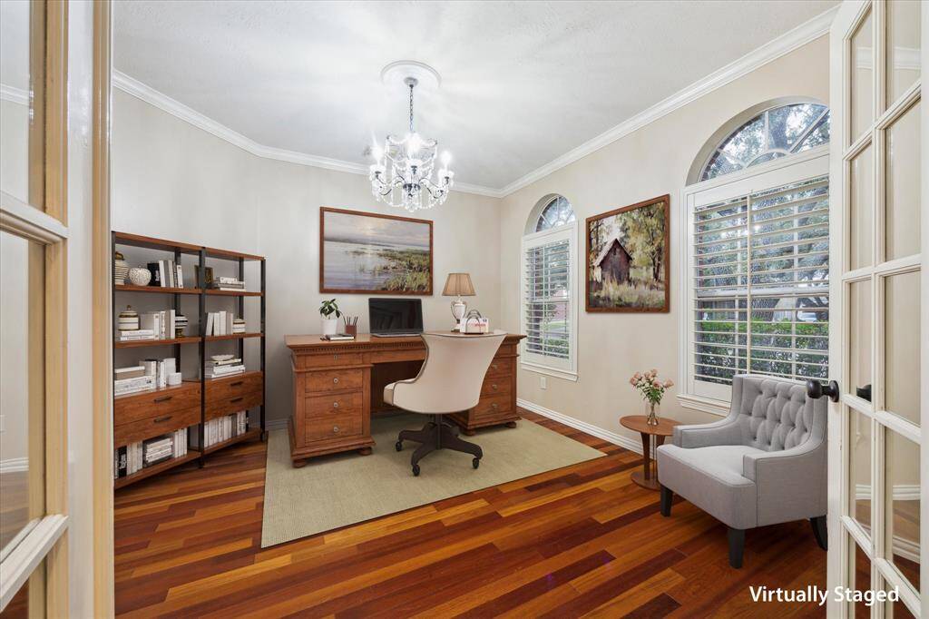 Home office features French doors, wood floors and plantation shutters.