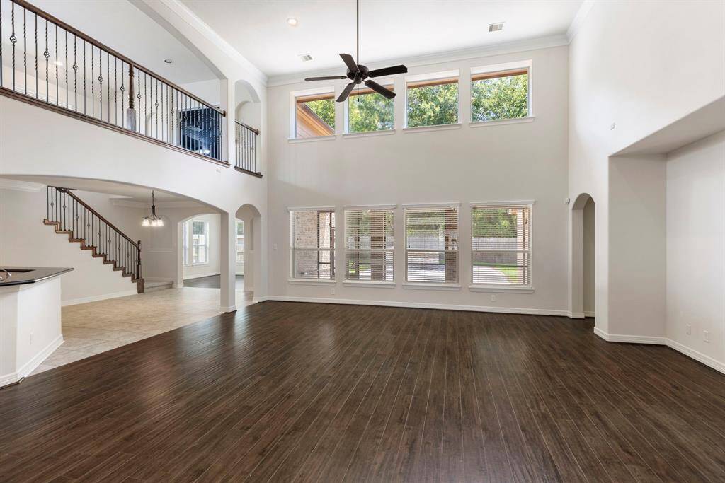 This room is a conversation piece with its wood-looking tile floors and floor to ceiling windows giving off tree top views.