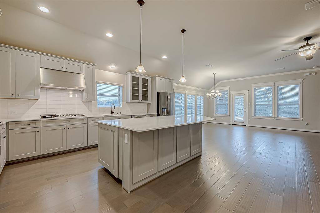 The open concept living area! Chef's kitchen, dining space, and family room all open to windows overlooking the water!