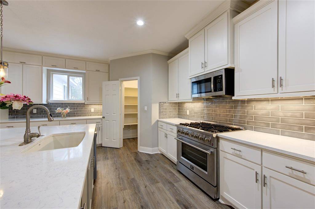The kitchen offers ample storage and expansive counter space, ensuring both functionality and elegance.