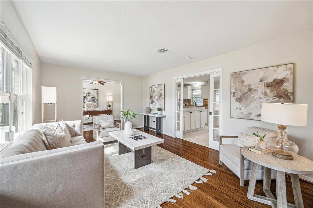 The family room provides the ideal space for gatherings with friends and family or quiet evenings in. Find gorgeous hardwood floors, an abundance of natural light, neutral paint, an adjoining study, and easy access to the kitchen and dining area through unique glass pocket doors.