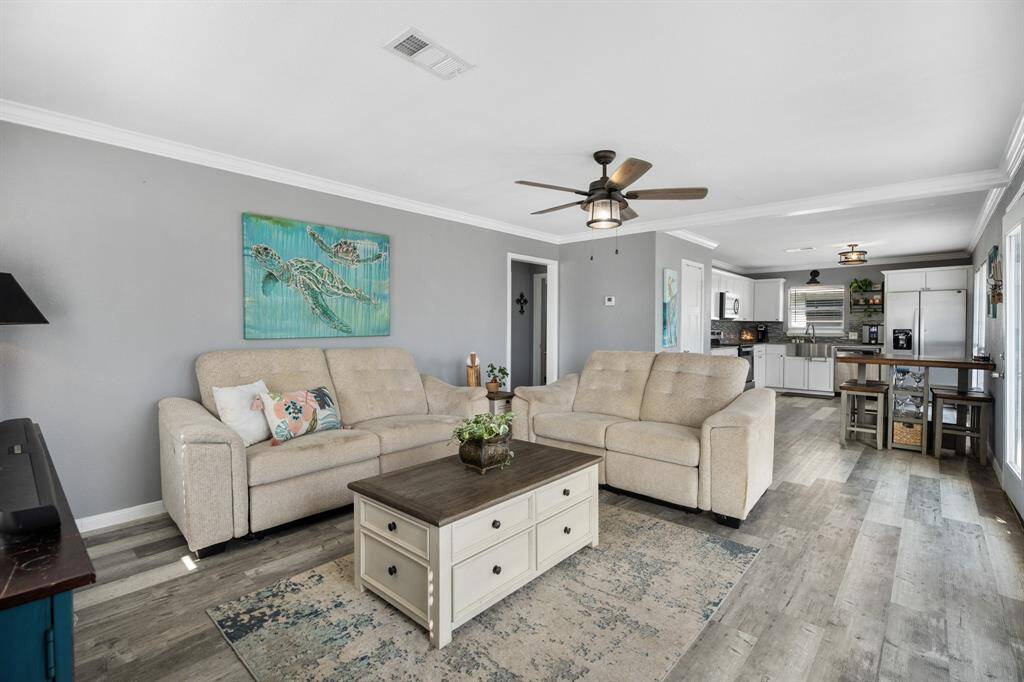 Step into your own island retreat, where light gray walls, touches of turquoise and durable vinyl plank floors create a harmonious blend of coastal charm and contemporary style. Perfectly designed for island living, this home offers a serene and inviting atmosphere that is both chic and practical.