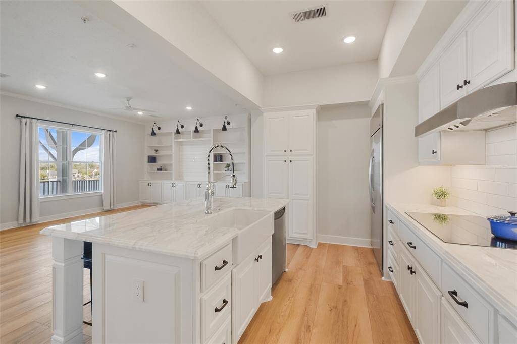 Inset kitchen with all the bells and whistles. Detailed island with electrical outlet for moveable appliances, Elkay farmhouse sink, dishwasher and Kohler Tournant Faucet with three-function sprayhead.