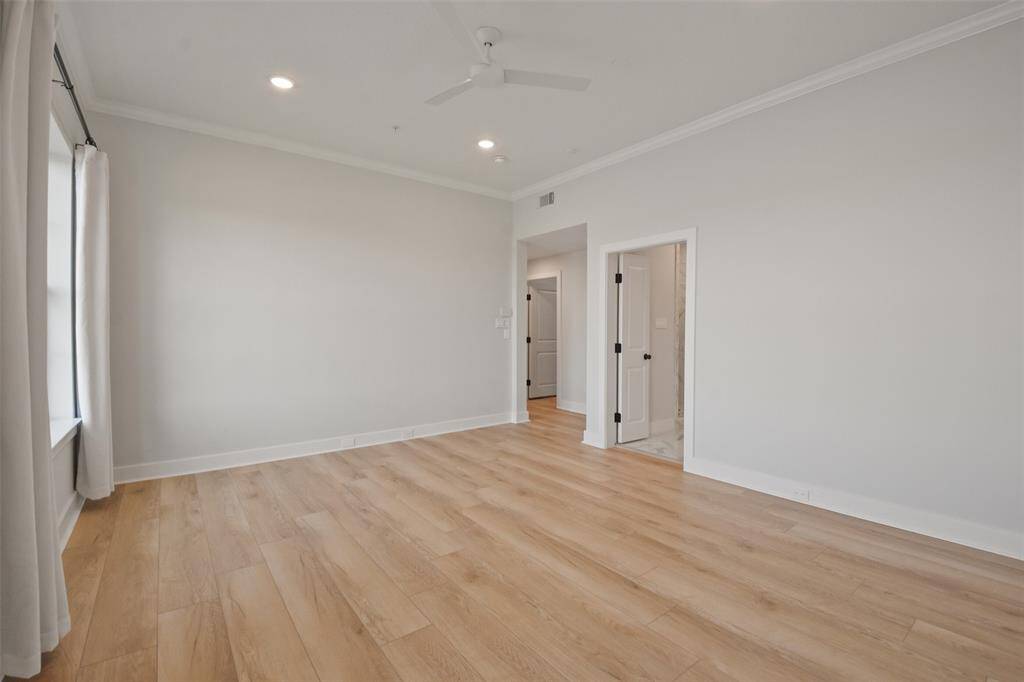 Owners Suite with private hallway leading into the walk-in closet and ensuite bathroom.