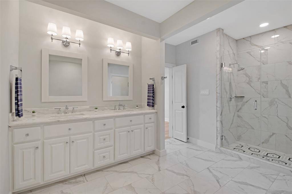 An additional view of the vanity area and walk-in shower in the Owners Suite bathroom. Oversized walk-in closet located right around the corner.