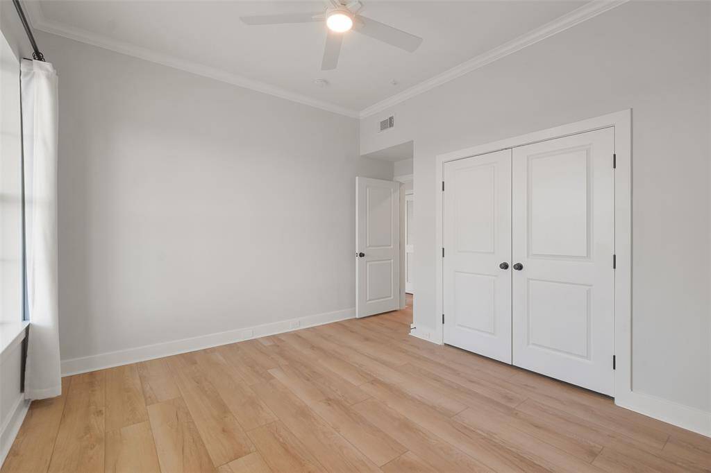 Features of this bedroom include a large closet with upper and lower hanging space and an updated fan with lighting; a full bathroom is located conveniently across the hall.