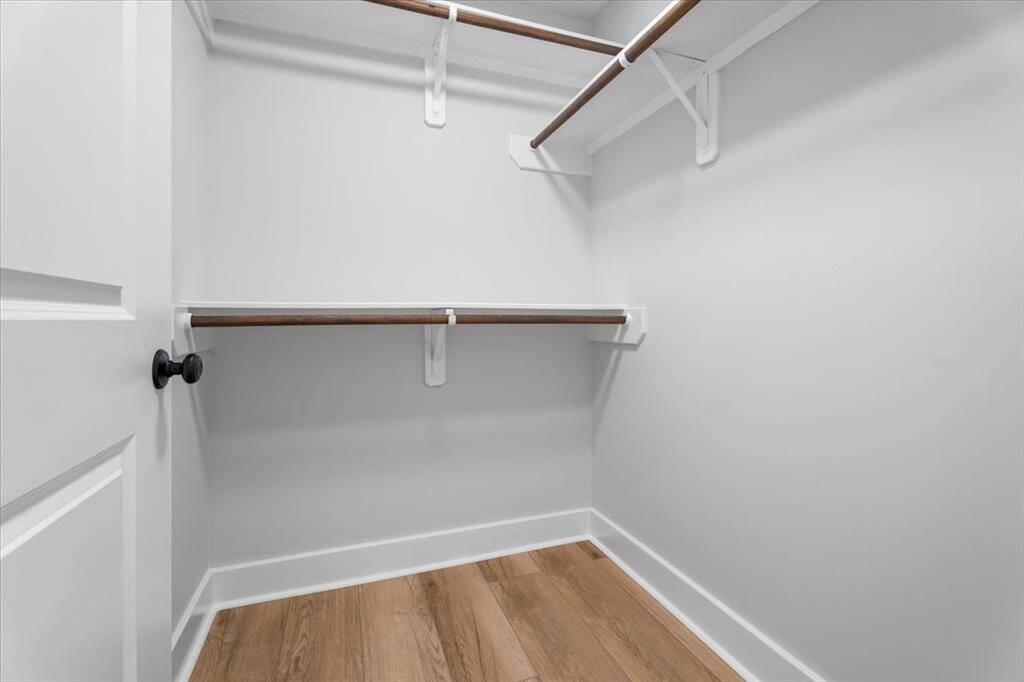 Guest Suite walk-in closet with ample space and luxury vinyl flooring.