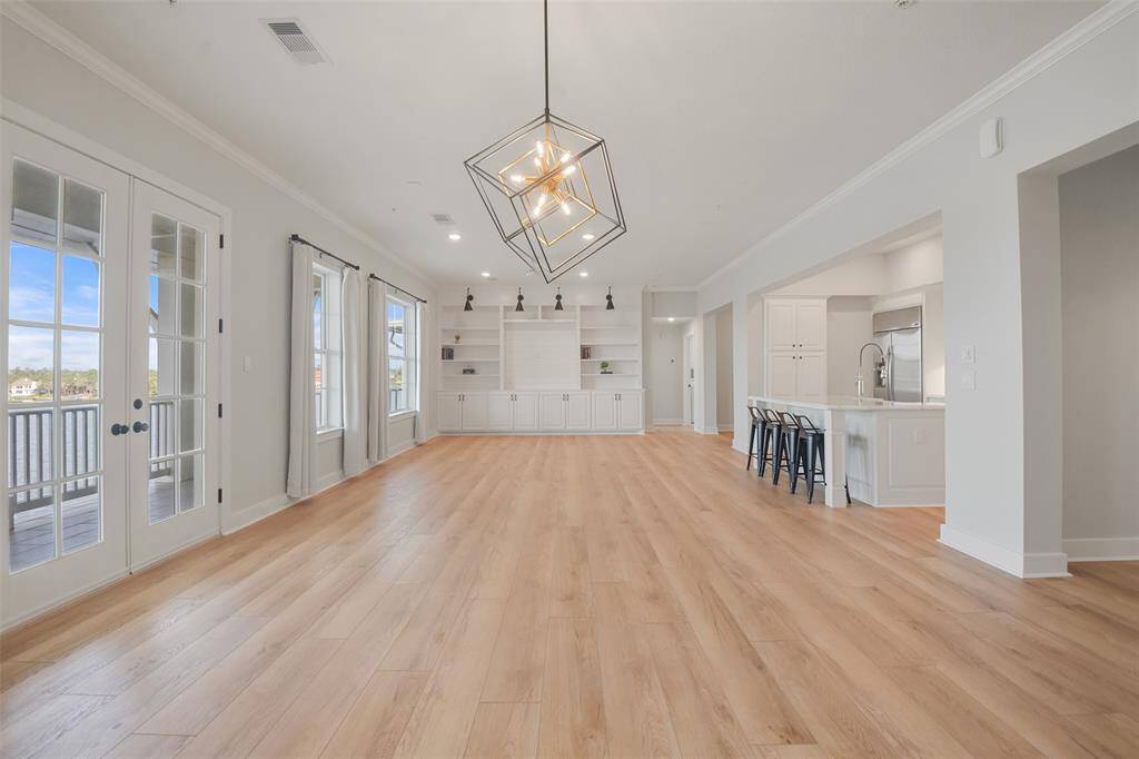 Upon entering, you will notice the natural lighting flooding in through the picturesque windows showcasing the gorgeous LVT flooring, updated modern fixtures and LED lighting.