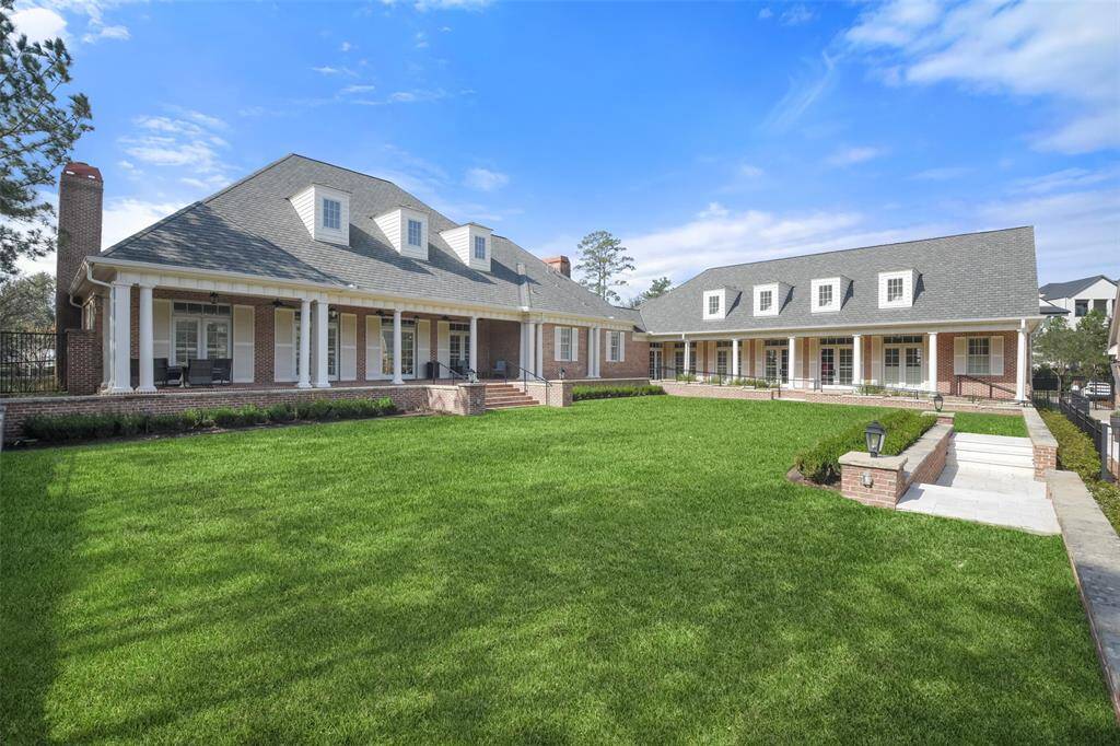 East Shore Club offering covered patio seating, lush green space and pool entrance.