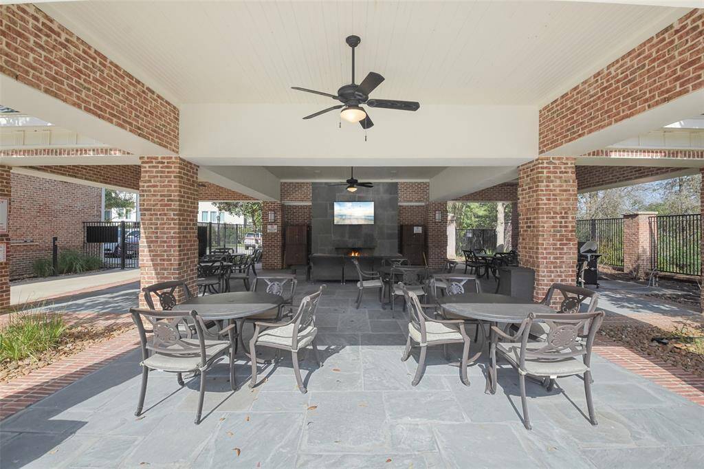 East Shore Club outdoor sitting area with fireplace, TV and grill.
