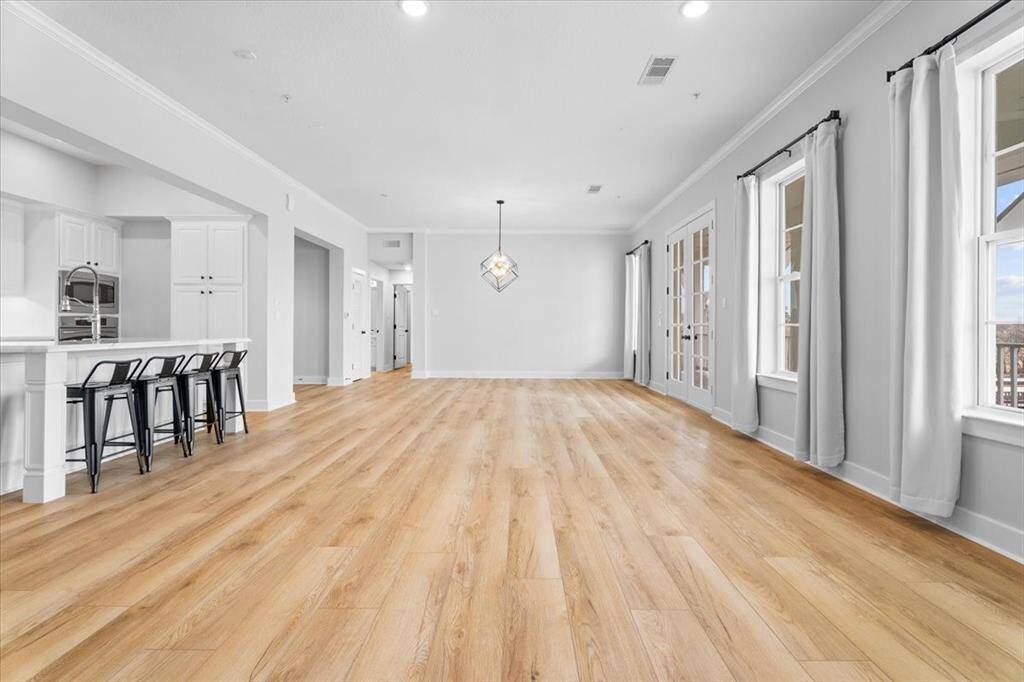 Open concept floor plan with kitchen, living room and dining room and full lake view with balcony access.