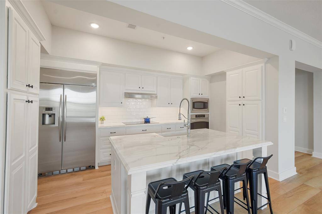 The stainless steel appliances including the built-in refrigerator, microwave, oven and dishwasher are beautiful!