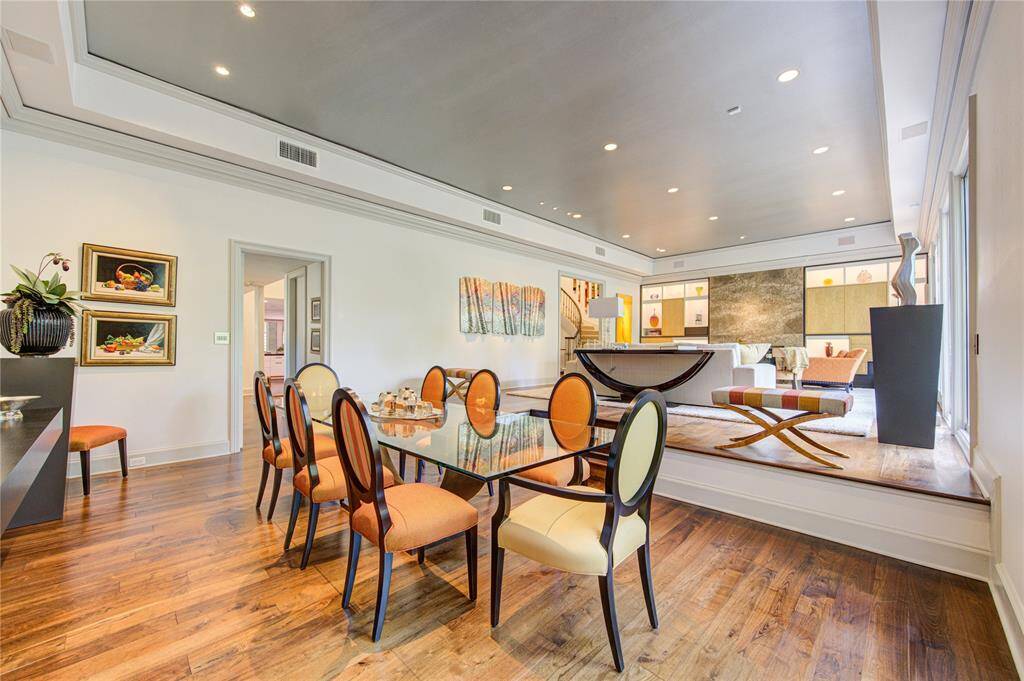 Another viewpoint of the dining that is open to the elevated living room area. Hardwood floors, recessed lighting, and an abundance of space.  The rooms are bright and inviting, ideal for entertaining.
