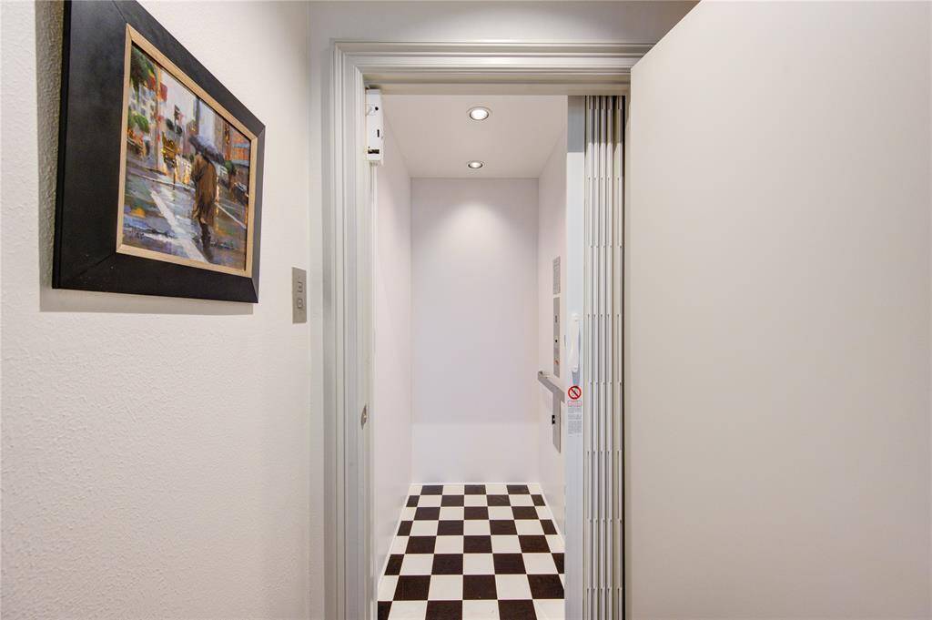 A home elevator was recently installed in 2021 with a checkered black & white floor.