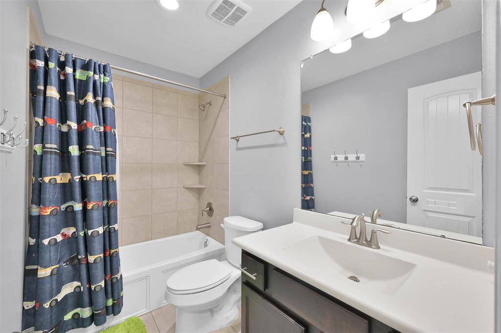 This full bathroom is located next to secondary bedroom #1. Cultured marble counter and sink, satin fixtures, and nice large mirror