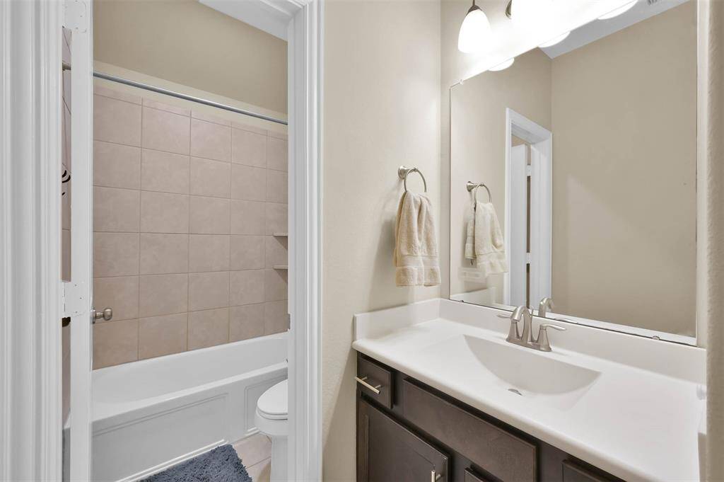 This is the 3rd full bathroom that is adjacent to secondary bedroom #2. Cultured marble counter and sink.