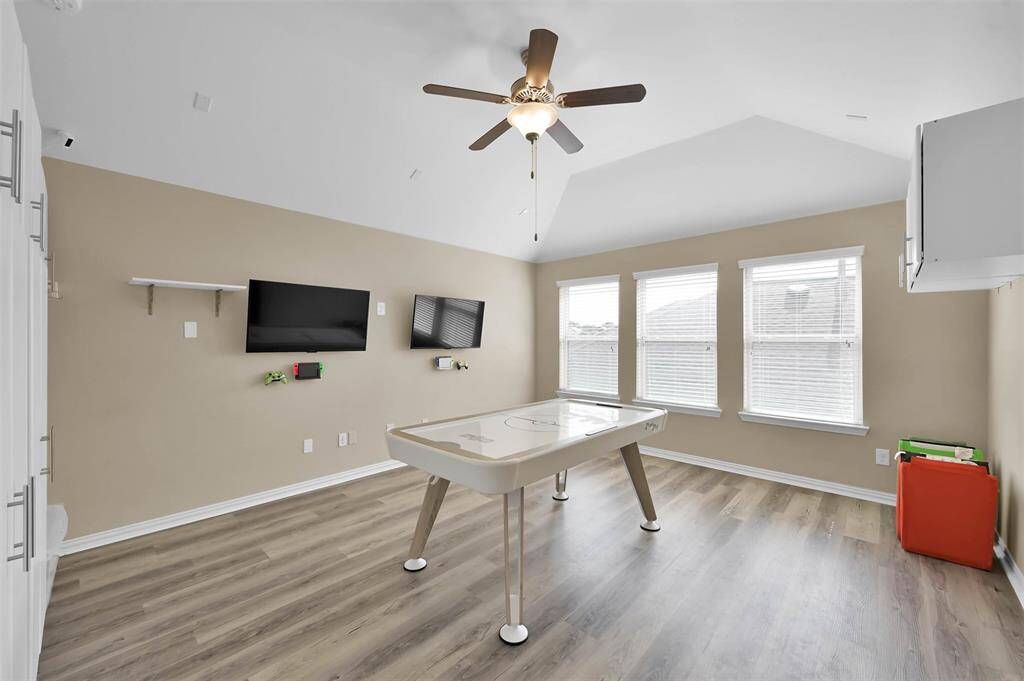 The upstairs game room is a retreat away from the rest of the house. Luxury vinyl flooring for easy care. High ceiling and great windows. This could also be a 4th bedroom if needed.