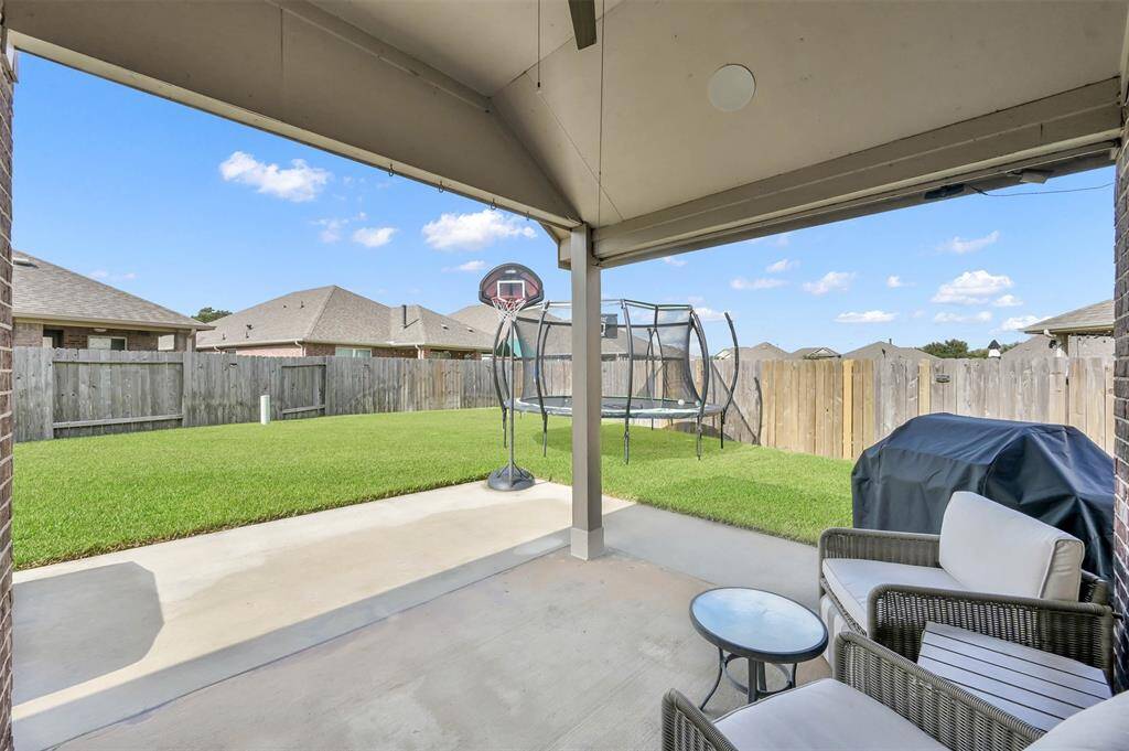 Backyard covered patio is ready for entertaining and relaxing. Complete with ceiling fan, speakers and a gas stub out for the grill.